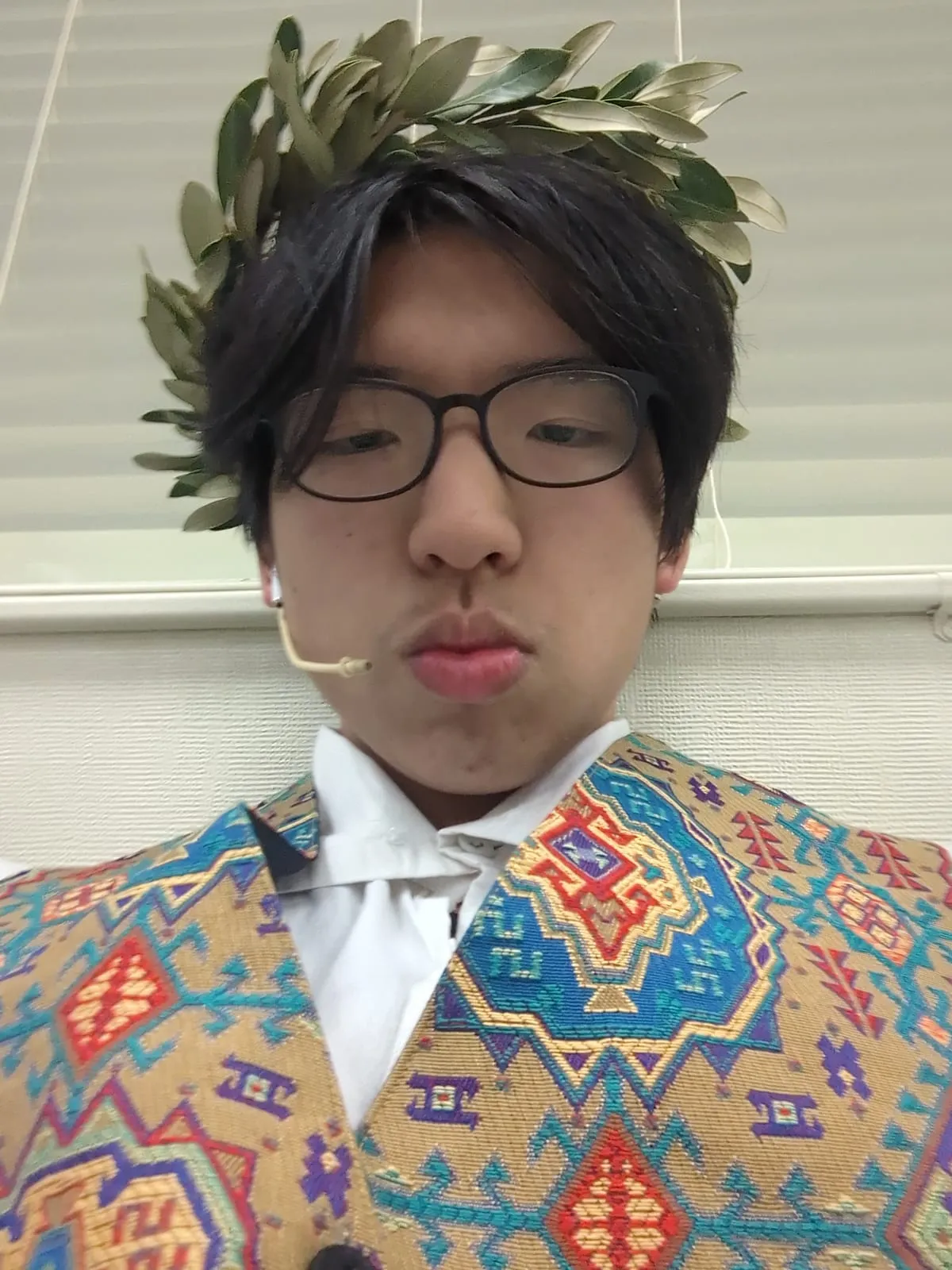 Ian in costume wearing a laurel wreath and a patterned jacket