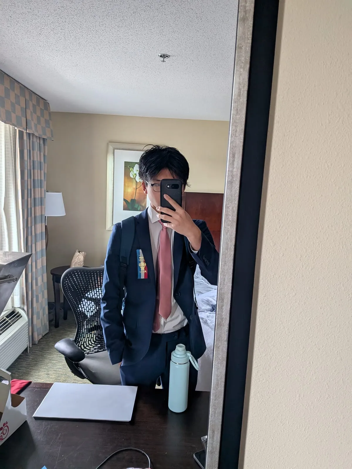Ian in a suit and tie, photographed in a mirror