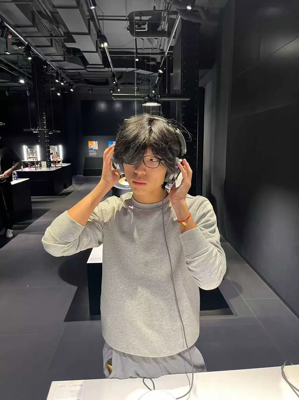 Ian Gao wearing headphones at a museum exhibit