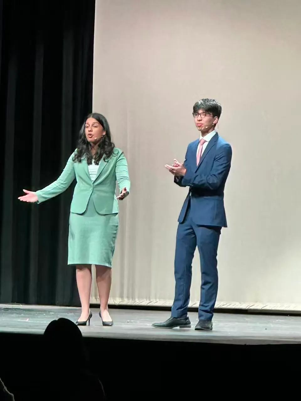 Ian speaking on stage, gesturing mid-sentence