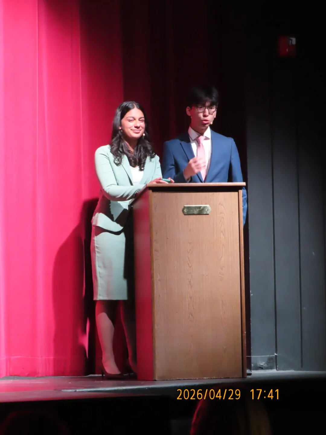 Ian speaking at a podium on stage