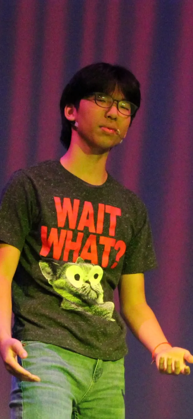 Ian performing on stage under coloured lights