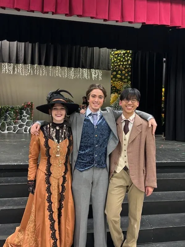 Ian and two castmates in period costume on stage